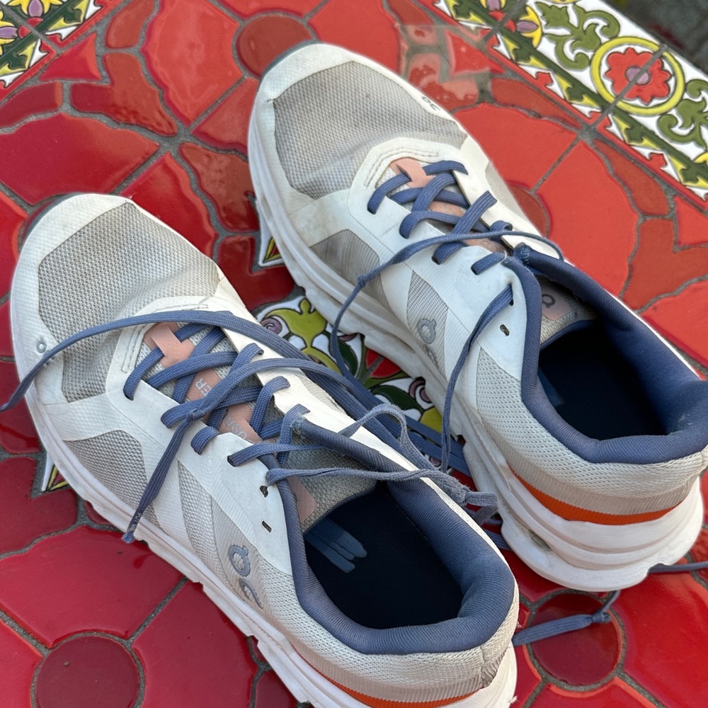 On Running White and Gray Shoes with Blue Laces